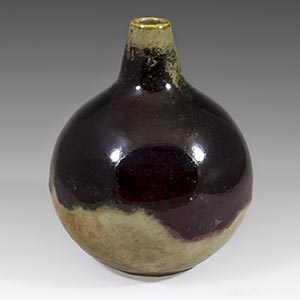 Hoganas ball vase in oxblood aand tan glaze. Unknown artist