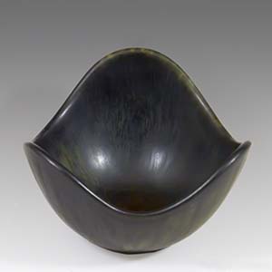 A small freeform bowl with a brown haresfur glaze  designed by Gunnar Nylund for Rorstrand of Sweden